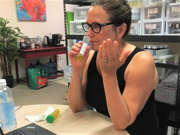 Owner Laurie Miller smelling a sample