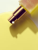 Nani Pua serum pump with product dispersed in background 
